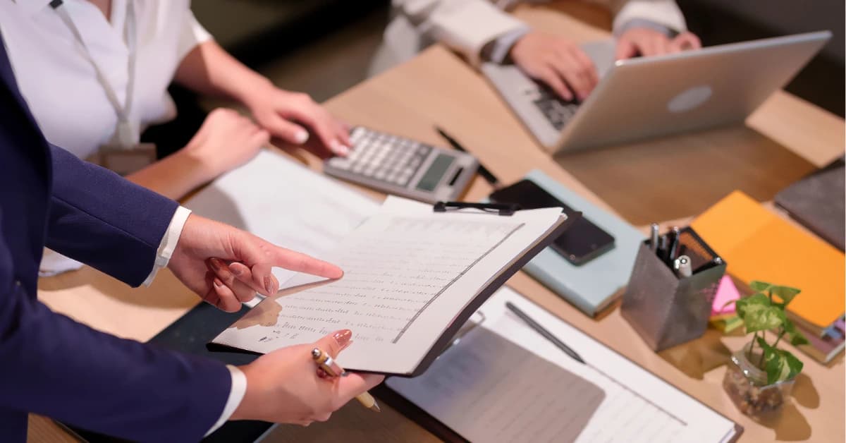 Business team reviewing regulation crowdfunding documentation and financial records during professional audit services