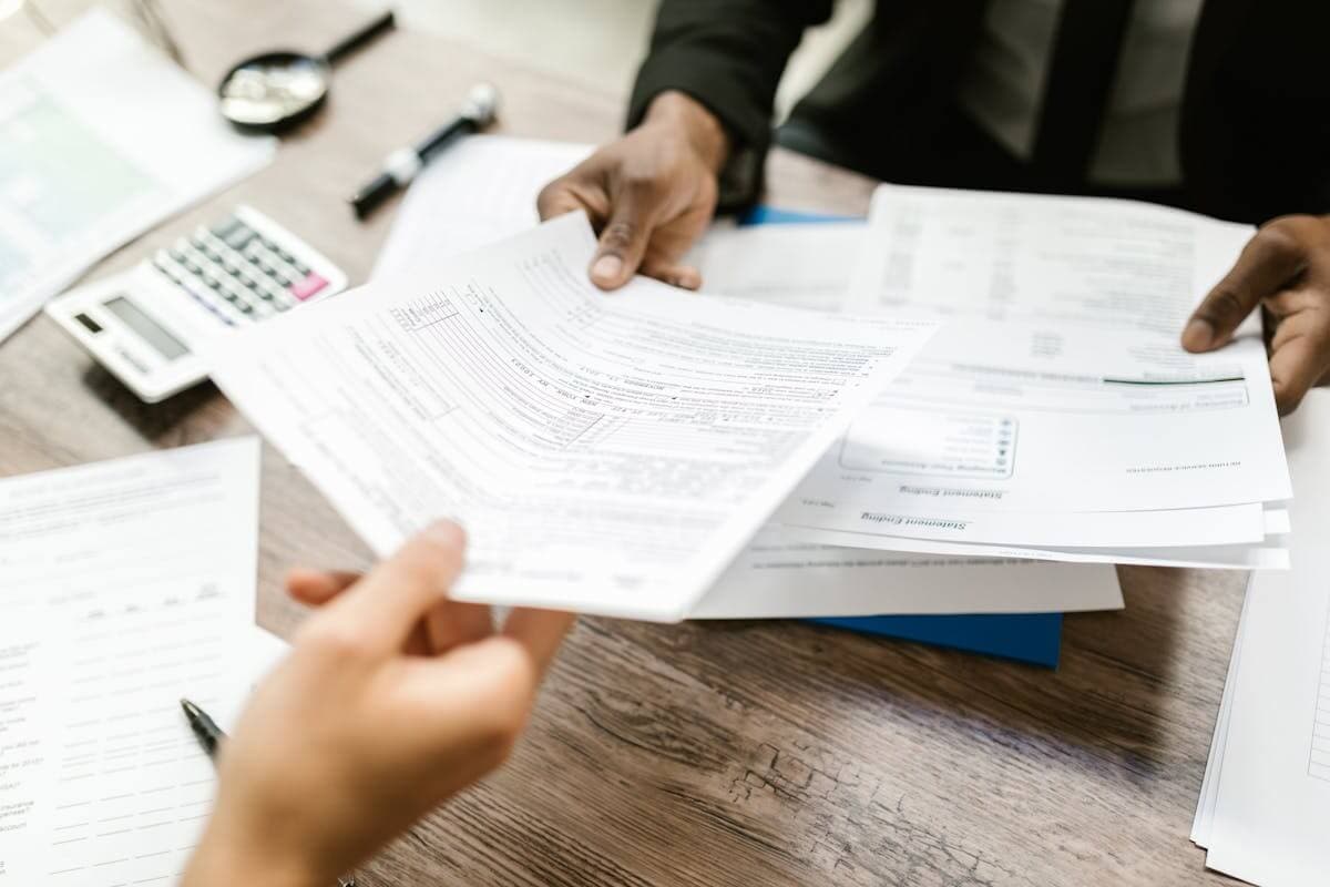Two people reviewing a printed report across a desk